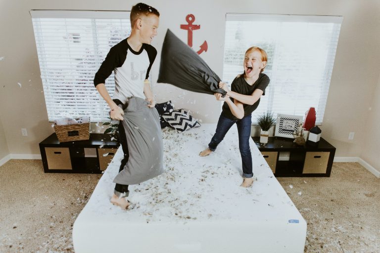 Boy and girl pillow fight